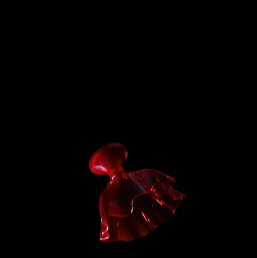 A small translucent red glass form glowing alone in an expanse of black.